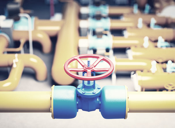 Interligações de tubulação de gás dentro de empresa, nas cores amarelo, azul e vermelho