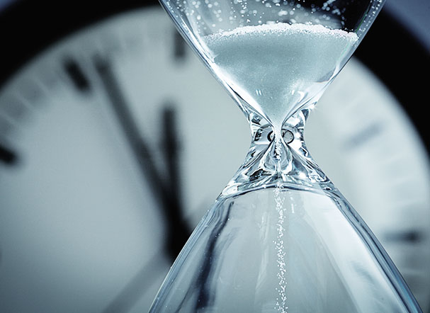 Image showing an hourglass in front of a clock